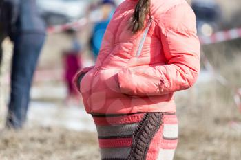 Pregnant girl in a pink jacket outdoor