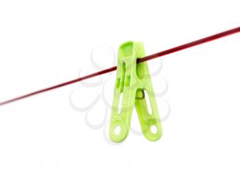 Green clothespin on a rope on a white background