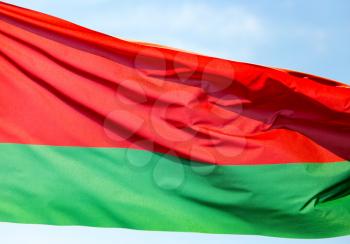 Flag of Belarus against the blue sky .