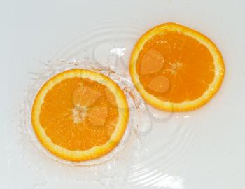 orange in water on white background