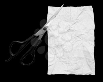 white sheet of paper with scissors on black background