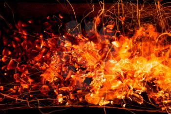 abstract background of burning coals of fire with sparks