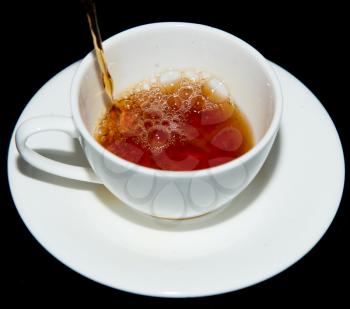 tea in a cup on a black background