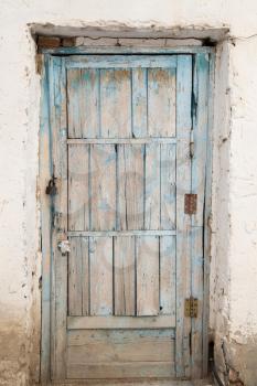 old wooden door on a white wall