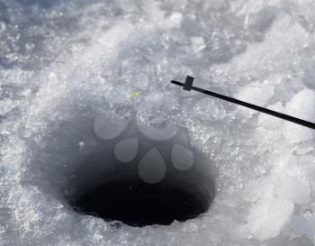 Fishing line in hole drilled in ice