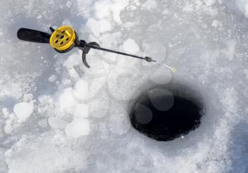 Fishing line in hole drilled in ice