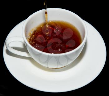 tea in a cup on a black background