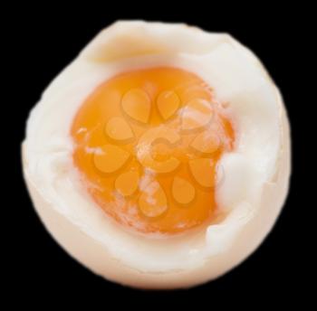 egg with yolk on black background