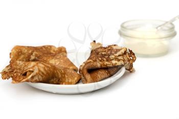 fried pancake with sour cream on a white background