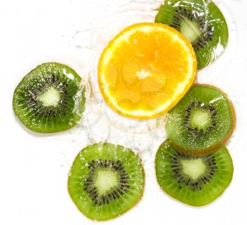 juicy kiwi and orange in water on a white background. macro