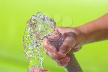 spray water from a hose child's hand
