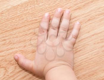 child's hand on the floor