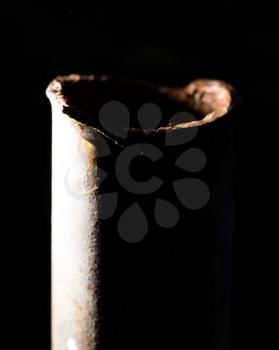 rusty pipe on black background