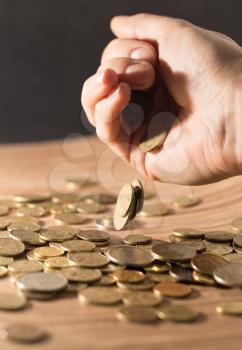 coins on the table and in hand