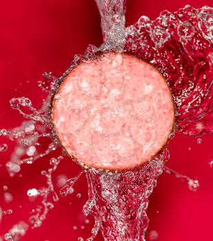 sausage in the water on a red background