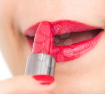 Applying lipstick