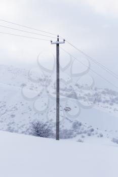 landscape with electric line castelluccio in the snow
