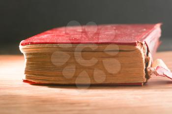 Red book on color background, education
