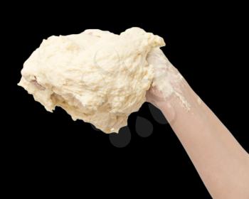 dough in hand on a black background