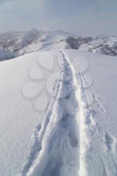 Trail in the snow in the mountains