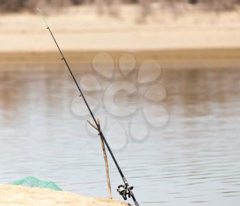 fishing rod on the river bank