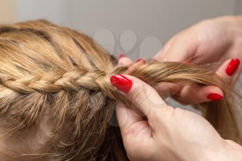 braided pigtails in the beauty salon
