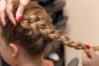 braided pigtails in the beauty salon
