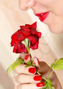 red rose, red manicure and red lips