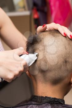 Man having a haircut with a hair clippers