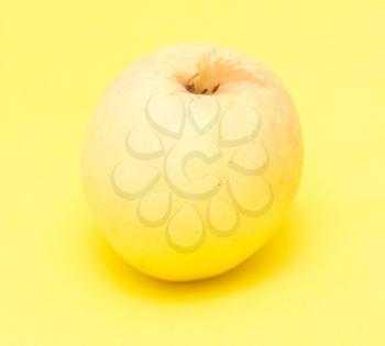 ripe apple on a yellow background