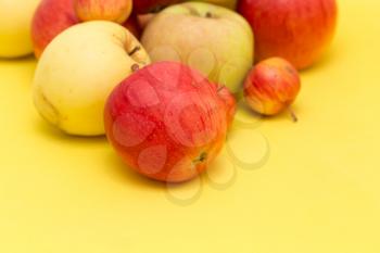 ripe apples on a yellow background
