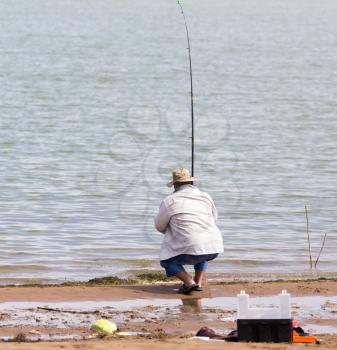 fisherman fishing on the lake