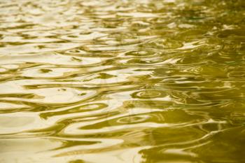 background of yellow surface of the water