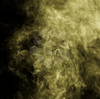 Yellow smoke against a black background