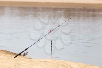 fishing rod on the river bank