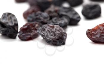 Black raisins on a white background. macro
