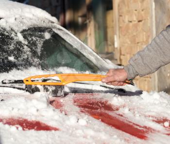 scraping snow from car winter