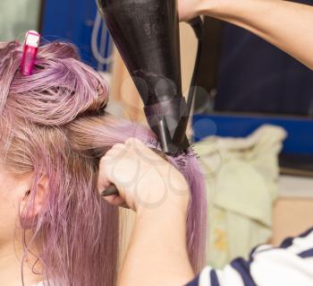 blow-drying hair in a beauty salon