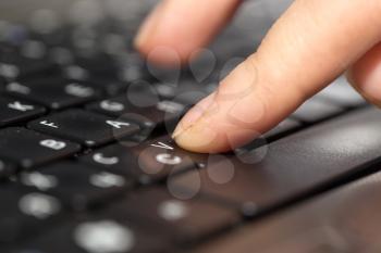 finger on a laptop keyboard