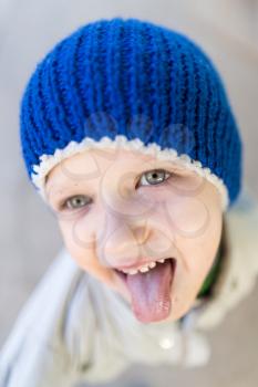 portrait of a boy showing tongue