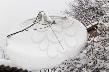 snow on the satellite dish in the winter