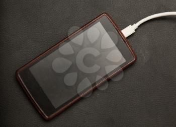 phone charging on a black background