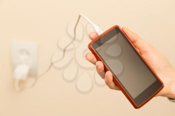 cell phone charging in your hand