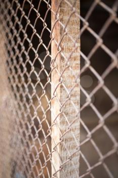 a fence of rusty metal mesh