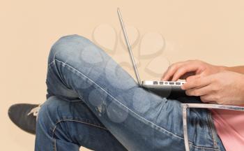 man in jeans with a laptop