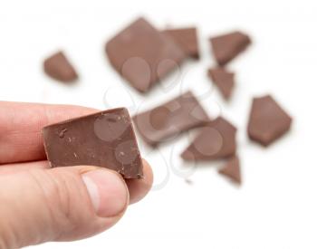 chocolate in his hand on a white background