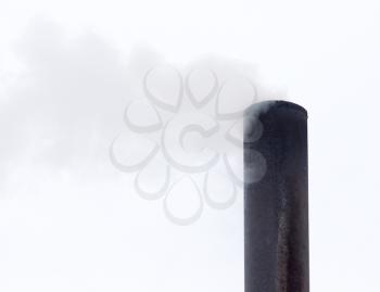 Smoke from a pipe on a cloudy sky