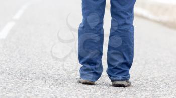 man standing on the road