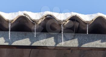 Long and dangerous icicles on a house roof