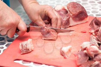 cutting meat with a knife